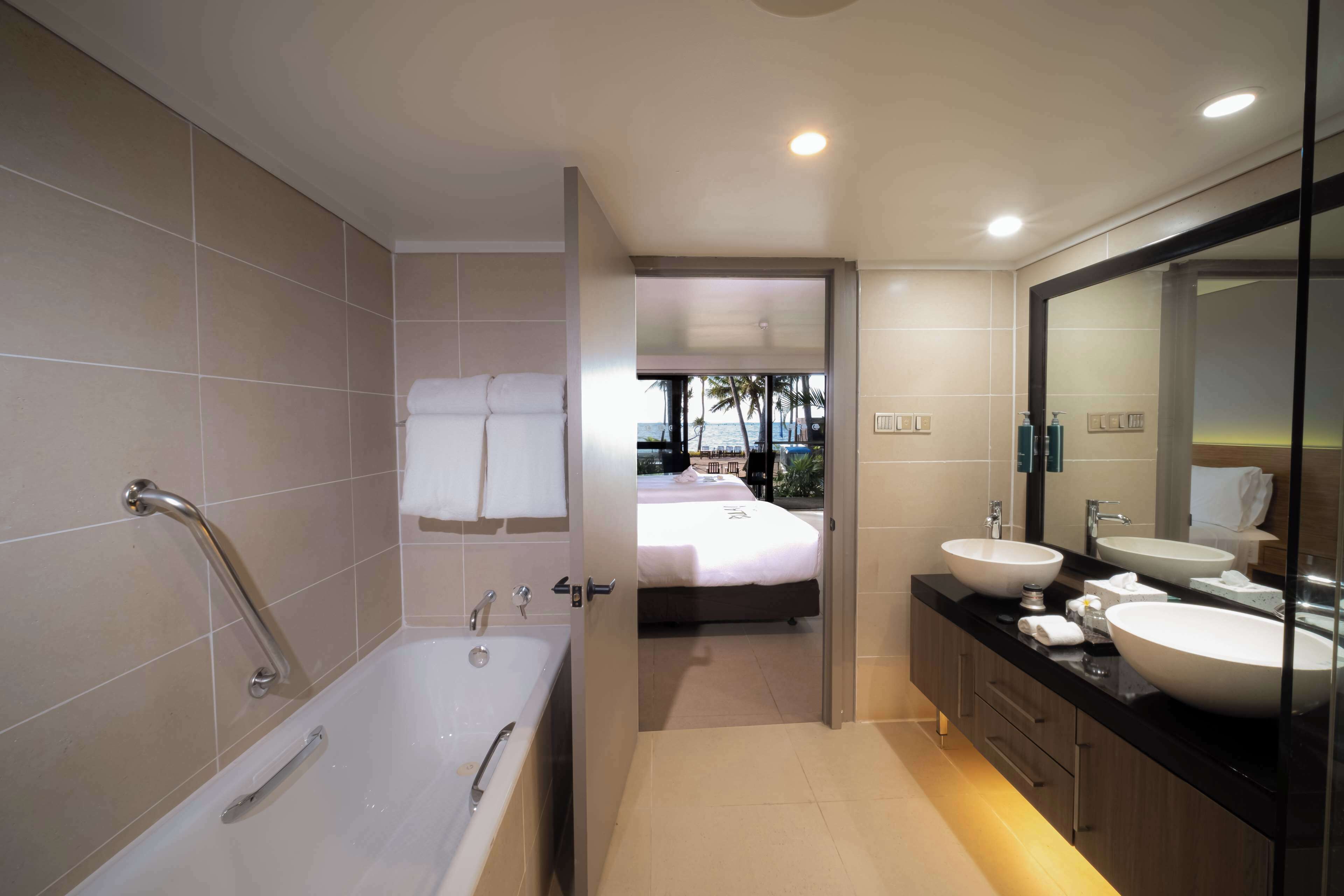 room, 2 queen beds, balcony, beachfront | bathroom | shower, free toiletries, hair dryer, bathrobes