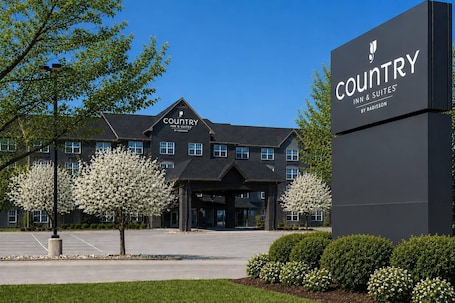 A Country Inn & Suites hotel with a large sign, a covered entrance, and a parking lot.. Country Inn & Suites by Radisson, Boise West - Meridian