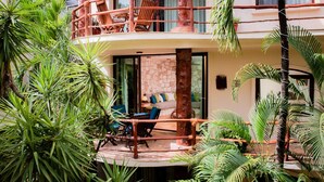 A two-story building with a balcony, surrounded by lush greenery. - Villas Sacbe Condo Hotel and Beach Club (Playa del Carmen)