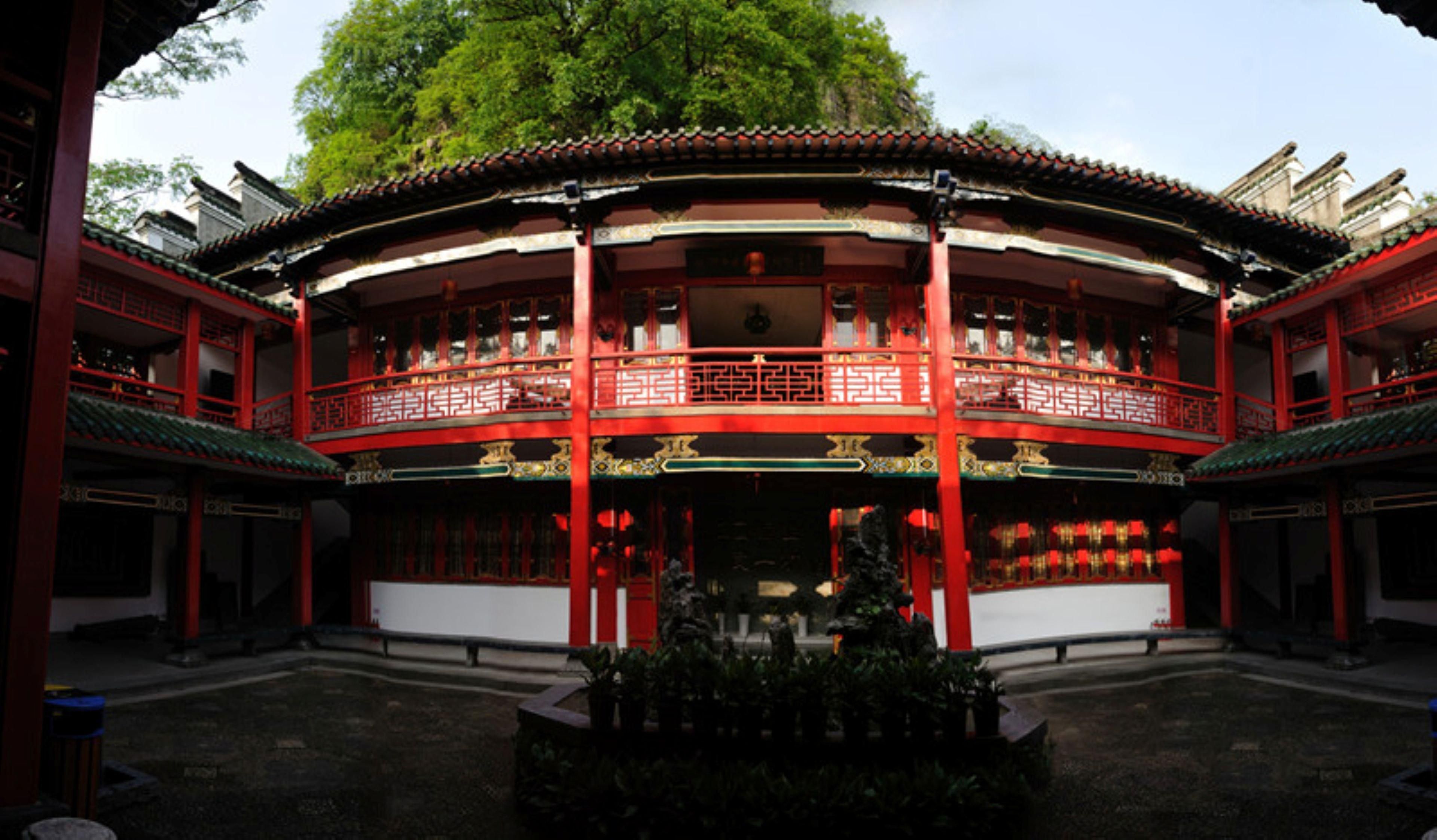 A traditional building with a symmetrical facade, multiple balconies, and a central open space.