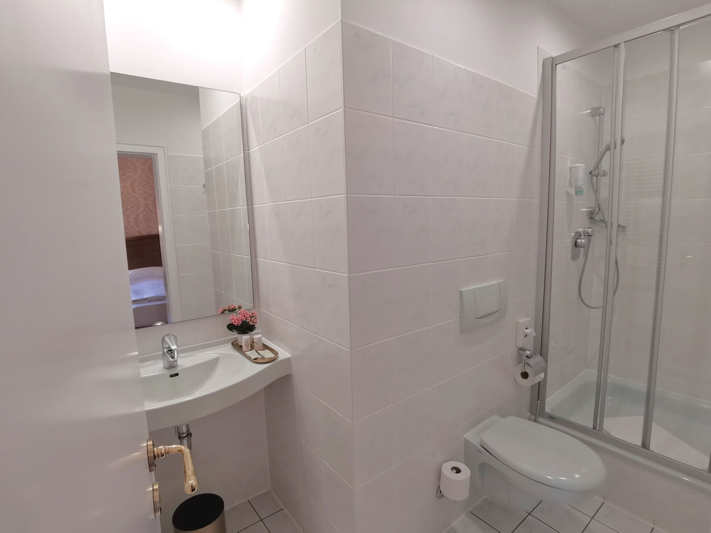 Ein Badezimmer mit Waschbecken, Toilette und einer Duschkabine.