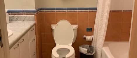 A compact bathroom with a toilet, a sink, and a bathtub.