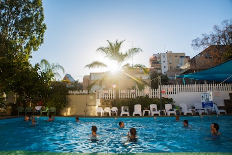 Seasonal outdoor pool, open 11:00 AM to 6:00 PM, pool umbrellas. Astoria Galilee Hotel