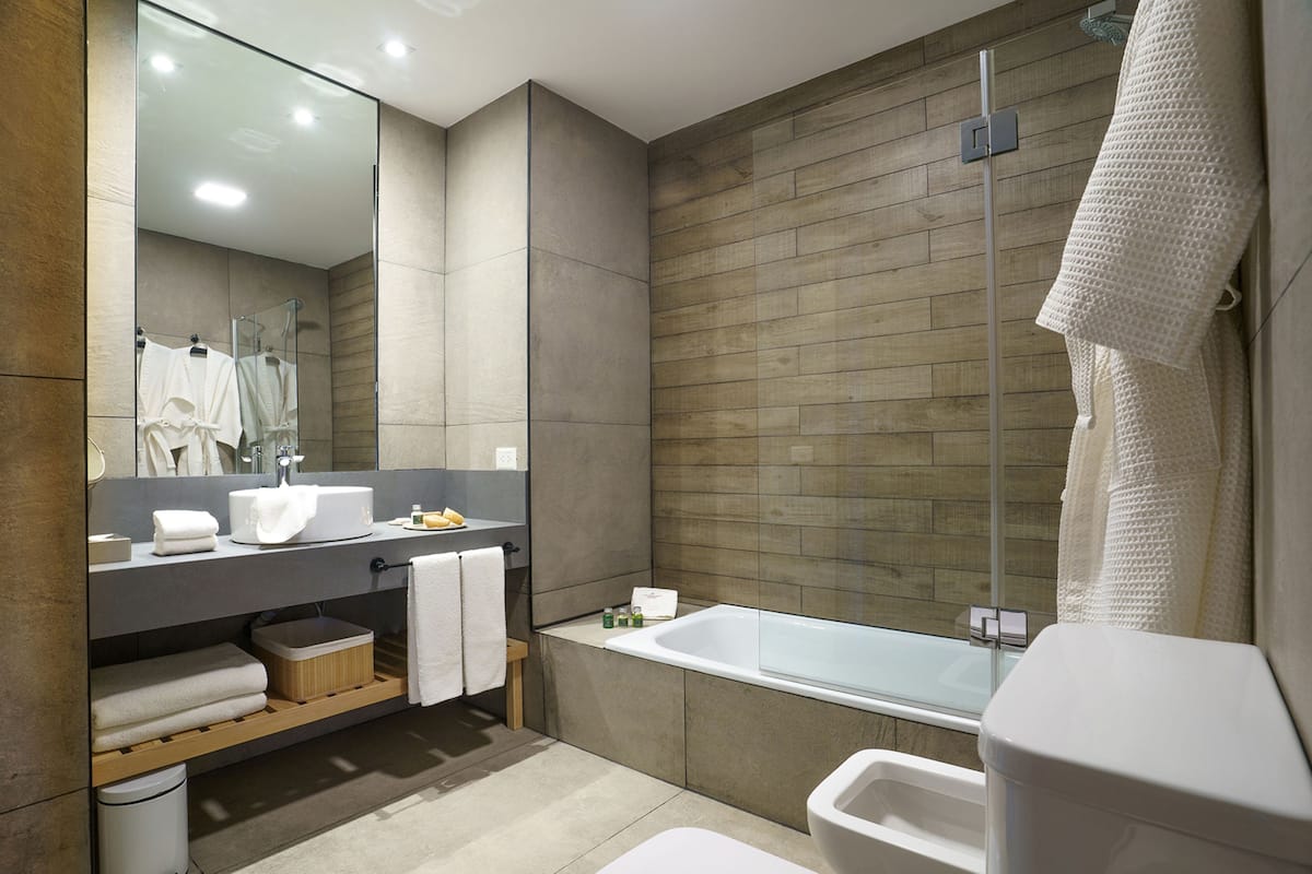 junior suite, 1 king bed, canal view | bathroom | combined shower/bathtub, rainfall showerhead, free toiletries