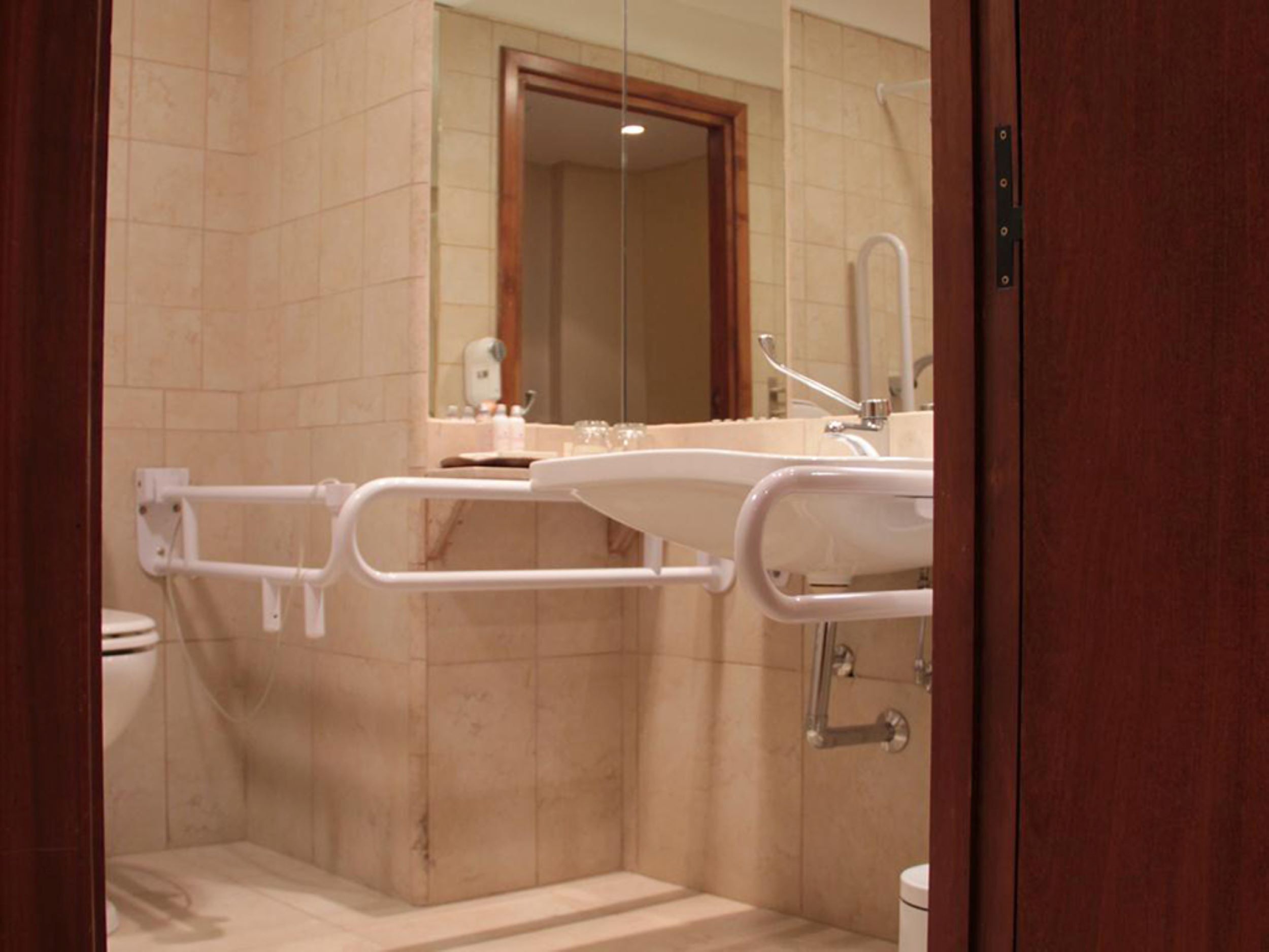 A bathroom with a shower, toilet, and sink.