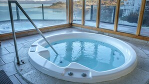 Un jacuzzi con vista a un lago y montañas.