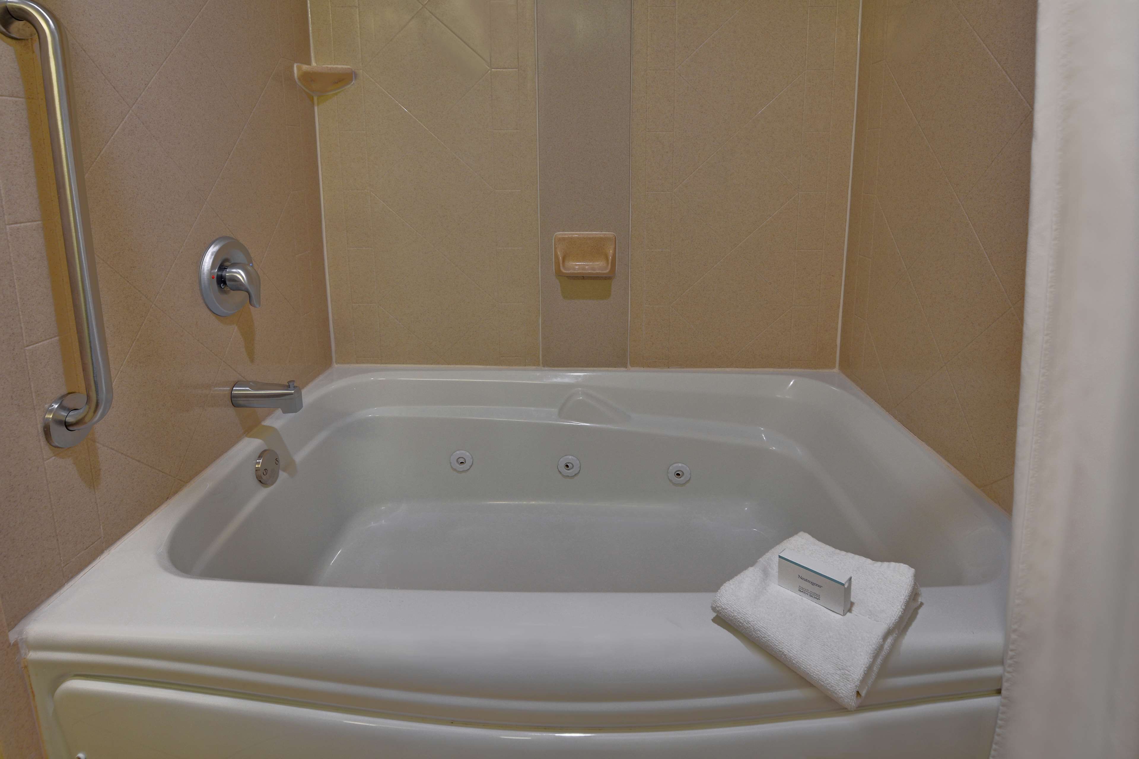 studio suite, 1 king bed, jetted tub | bathroom | combined shower/bathtub, free toiletries, hair dryer, towels