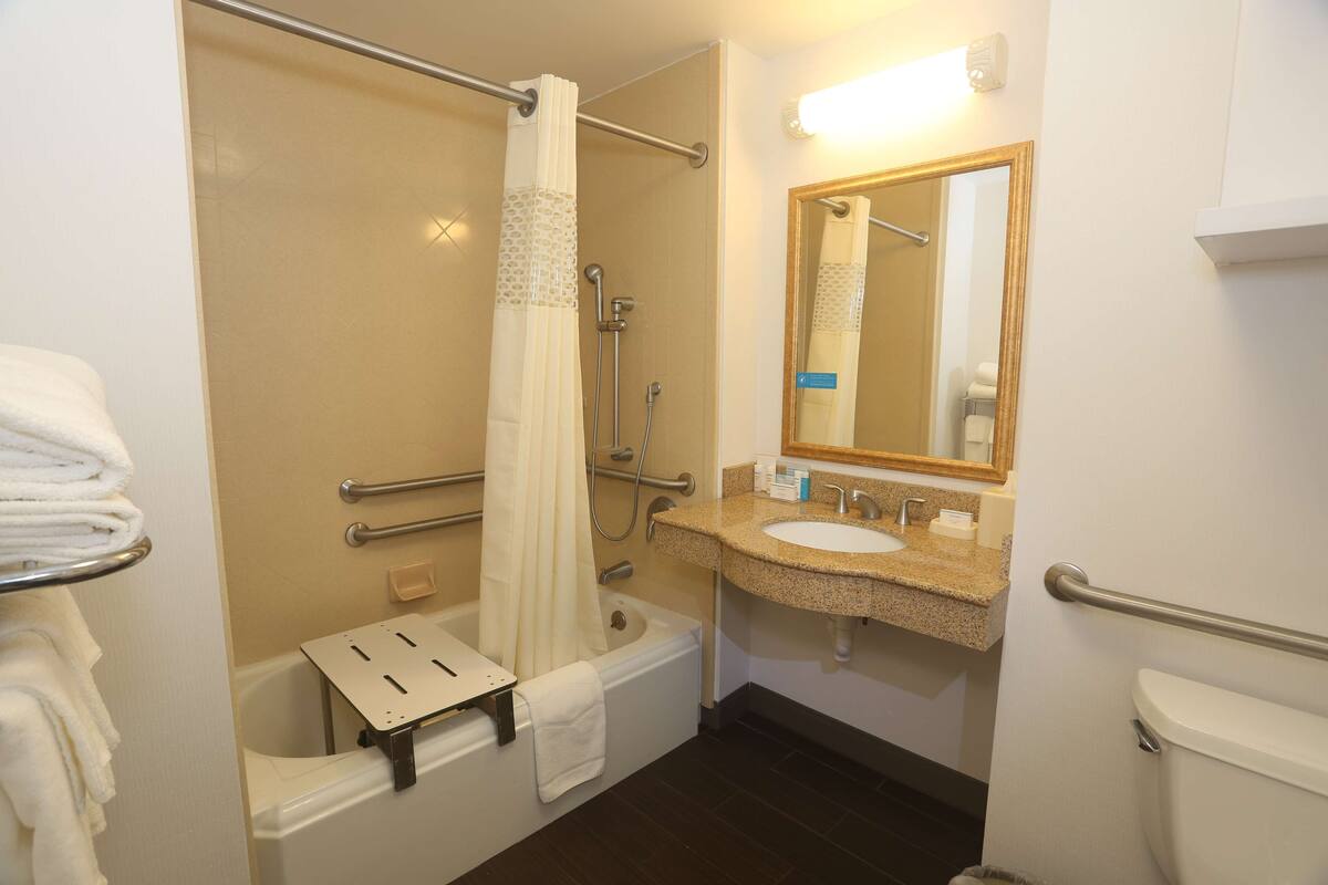 A bathroom with a bathtub, a shower, a sink, and a toilet.