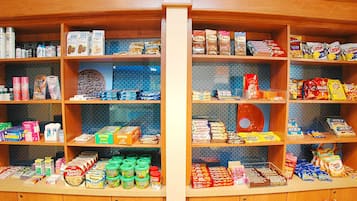 A snack and pantry section with various food items and household goods.