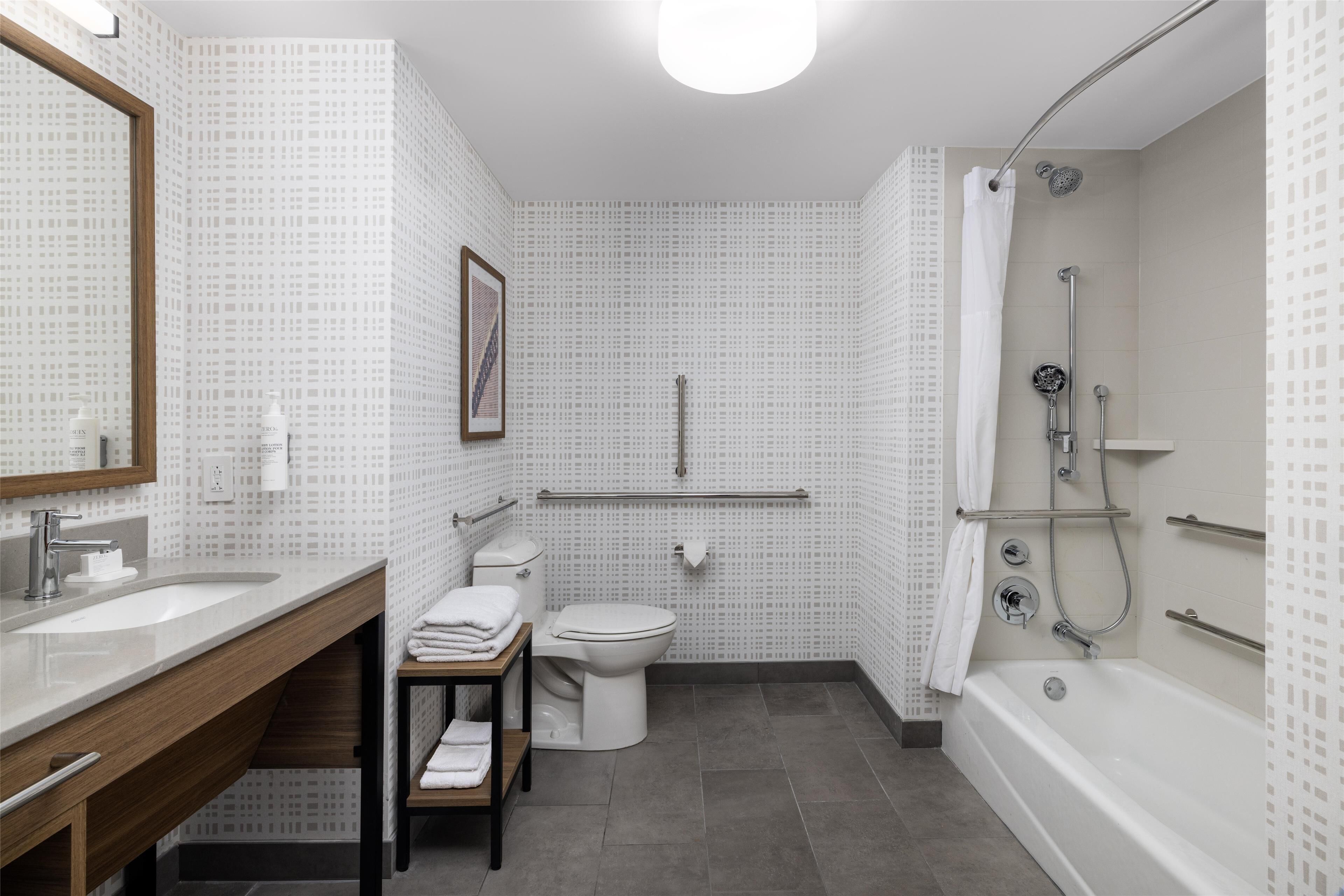 designer toiletries, hair dryer, towels