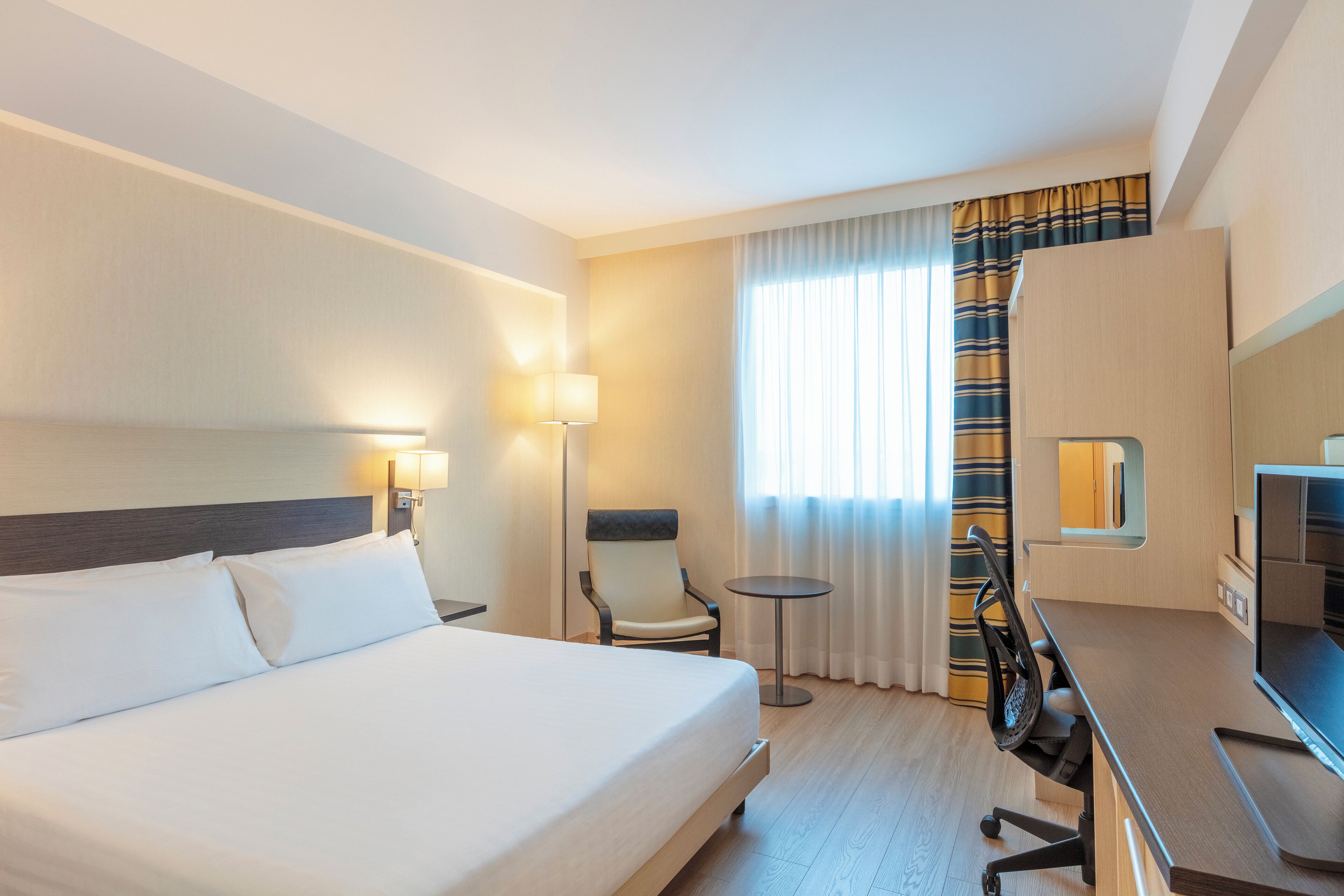 غرفة - سرير ملكي | أسرّة سليكت كومفورت وخزنة داخل الغرفة ومكتب وستائر تعتيم