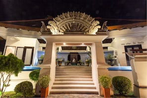 A grand entrance with a staircase leading to a gated area, surrounded by potted plants and architectural details. - The Briza Beach Resort, Samui (Koh Samui)