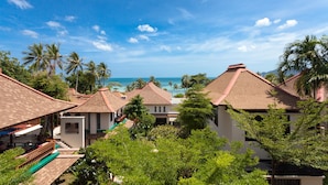 A resort with multiple bungalow-style buildings, a pool area, and a view of the ocean. - The Briza Beach Resort, Samui (Koh Samui)