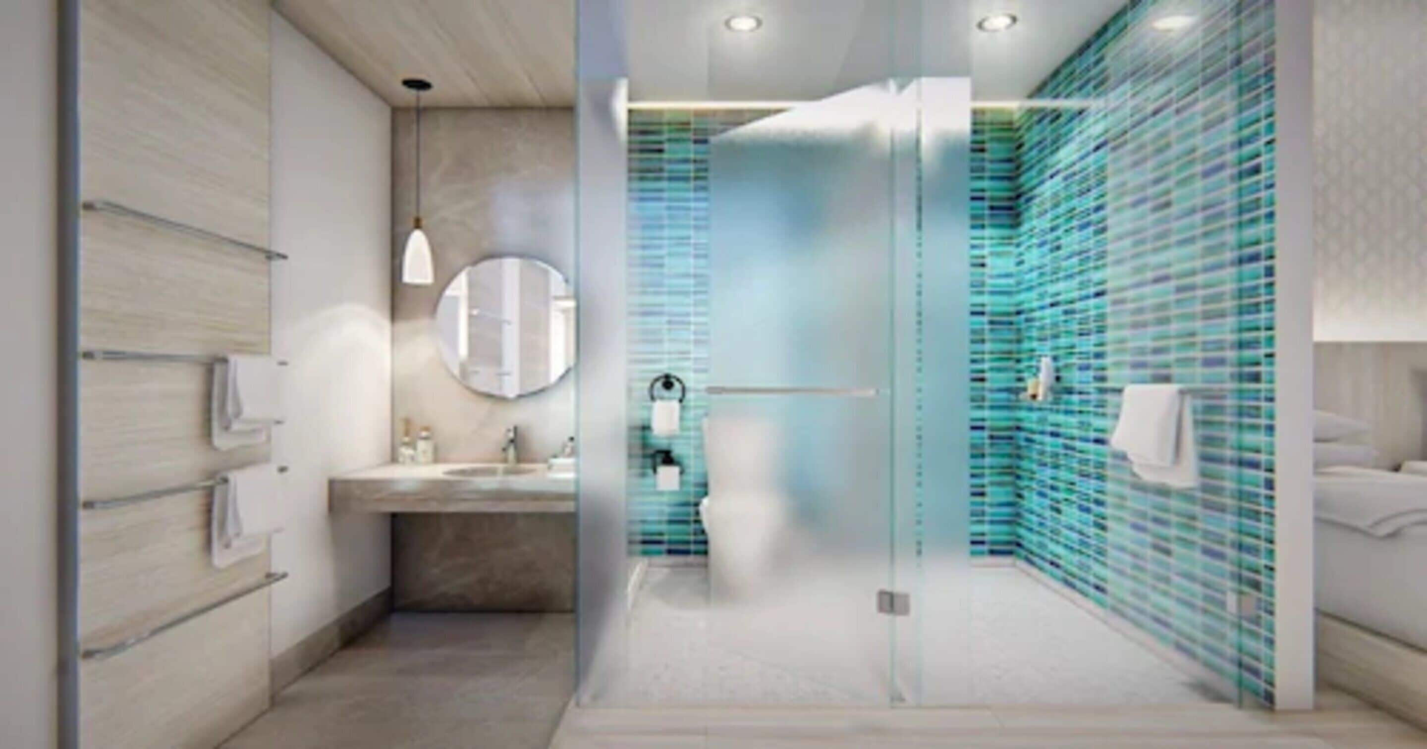 Une salle de bain moderne avec une douche à l’italienne en verre, un miroir rond et un mur recouvert de carreaux.
