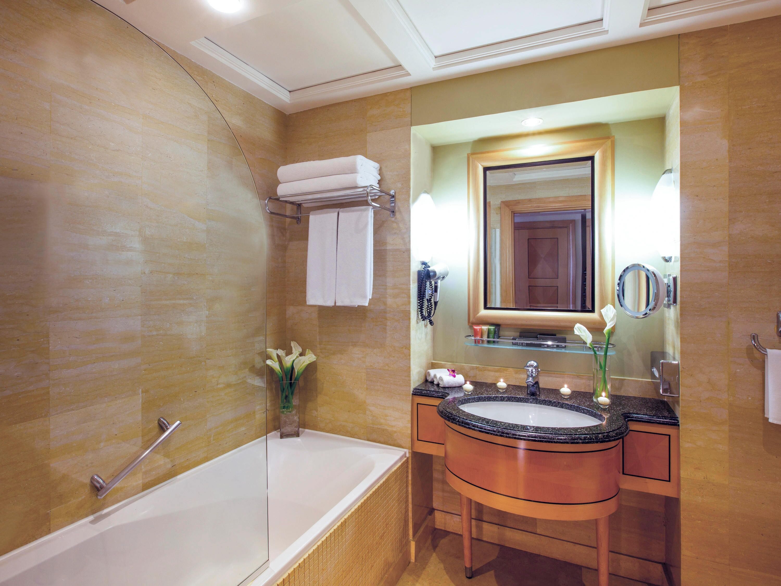 bathtub, eco-friendly toiletries, hair dryer, bathrobes