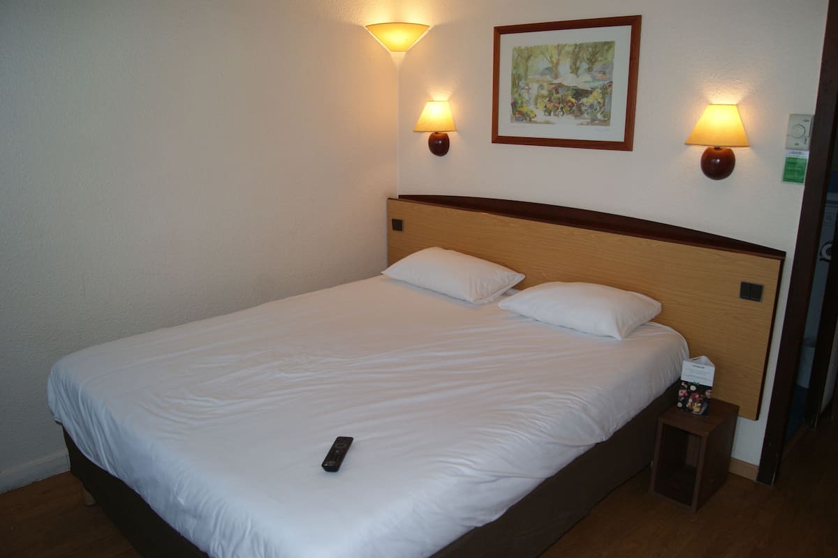 Premium bedding, desk, laptop workspace, blackout drapes