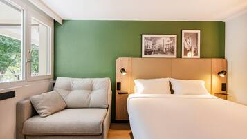 Premium bedding, desk, laptop workspace, blackout drapes