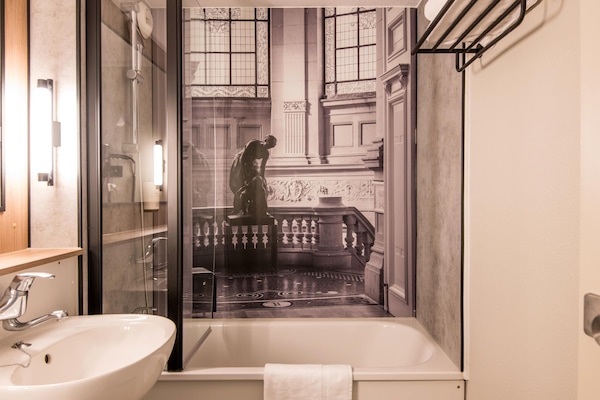 Bathtub, eco-friendly toiletries, hair dryer, towels
