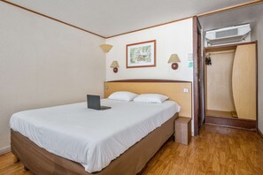 Premium bedding, desk, laptop workspace, blackout drapes