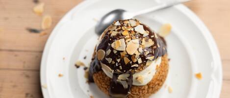 A dessert on a white plate with a spoon.