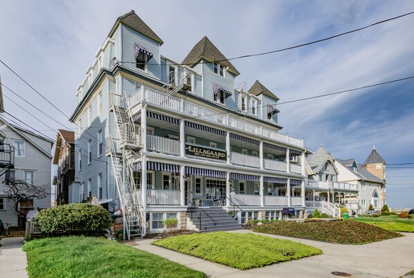 A multi-story building with a prominent sign reading "Lilligaard Bed and Breakfast." - The Lillagaard B&B (Ocean Grove)