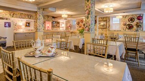 A dining area with tables set for service, chairs, and a buffet station. - The Lillagaard B&B (Ocean Grove)