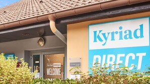 A hotel entrance with a large sign reading "Kyriad DIRECT" and a welcome sign. - Kyriad Direct Epinal (Epinal)