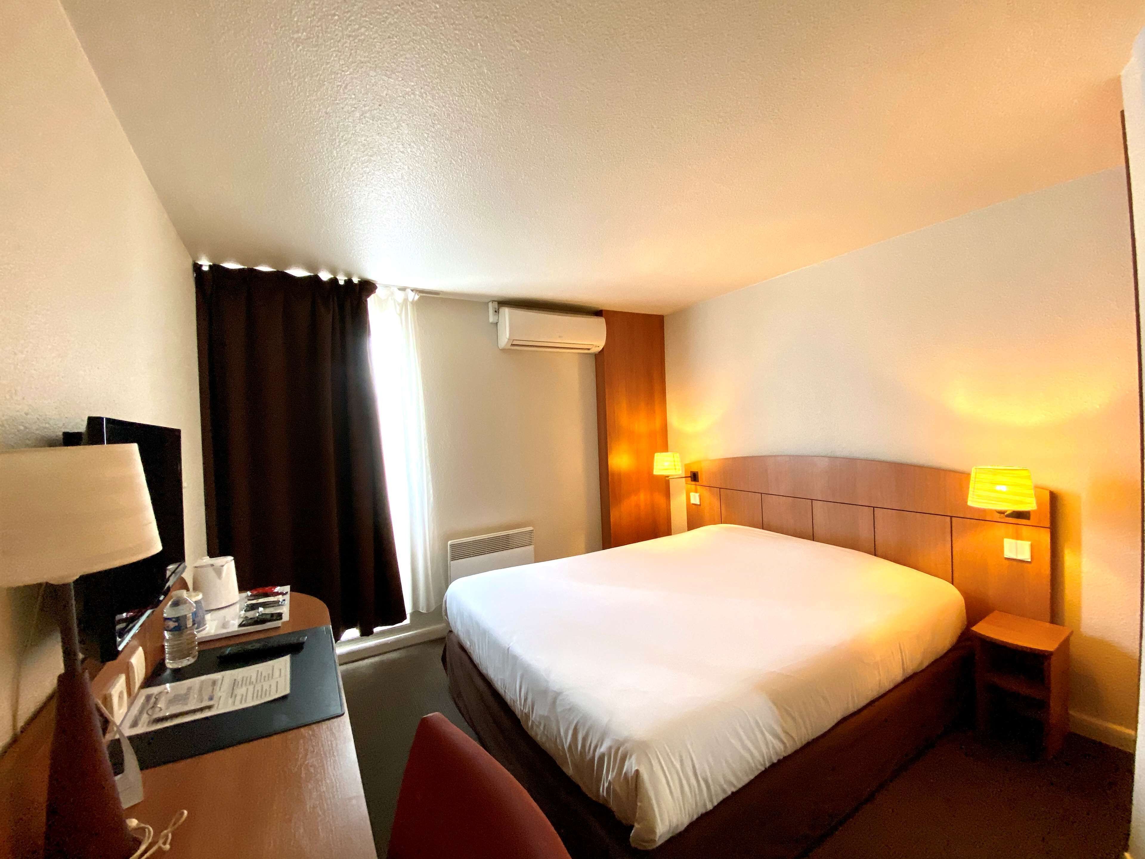 Premium bedding, desk, laptop workspace, blackout drapes