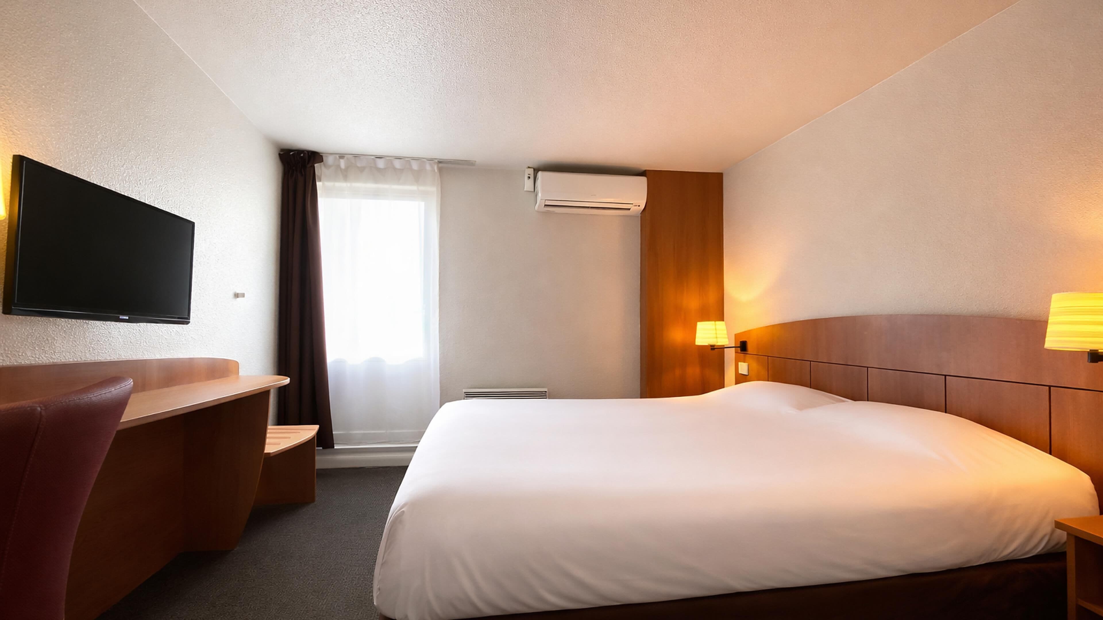 Premium bedding, desk, laptop workspace, blackout curtains