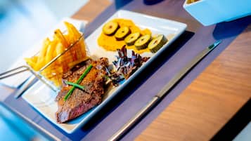 A plate of food with steak, fries, and vegetables.