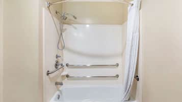 A standard bathtub with a showerhead, grab bars, and a towel rack.