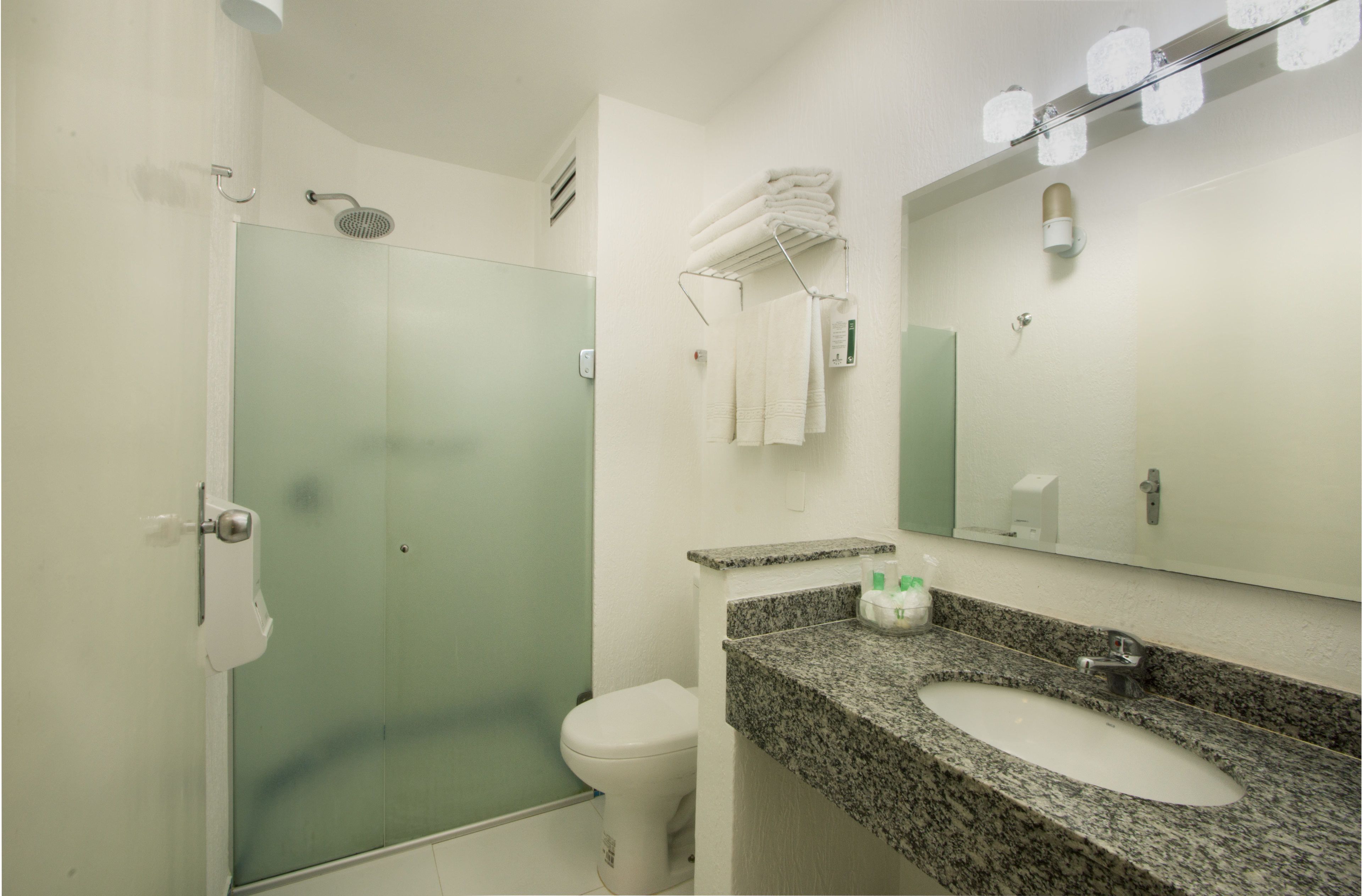 deluxe triple room | bathroom | shower, hair dryer, towels, soap