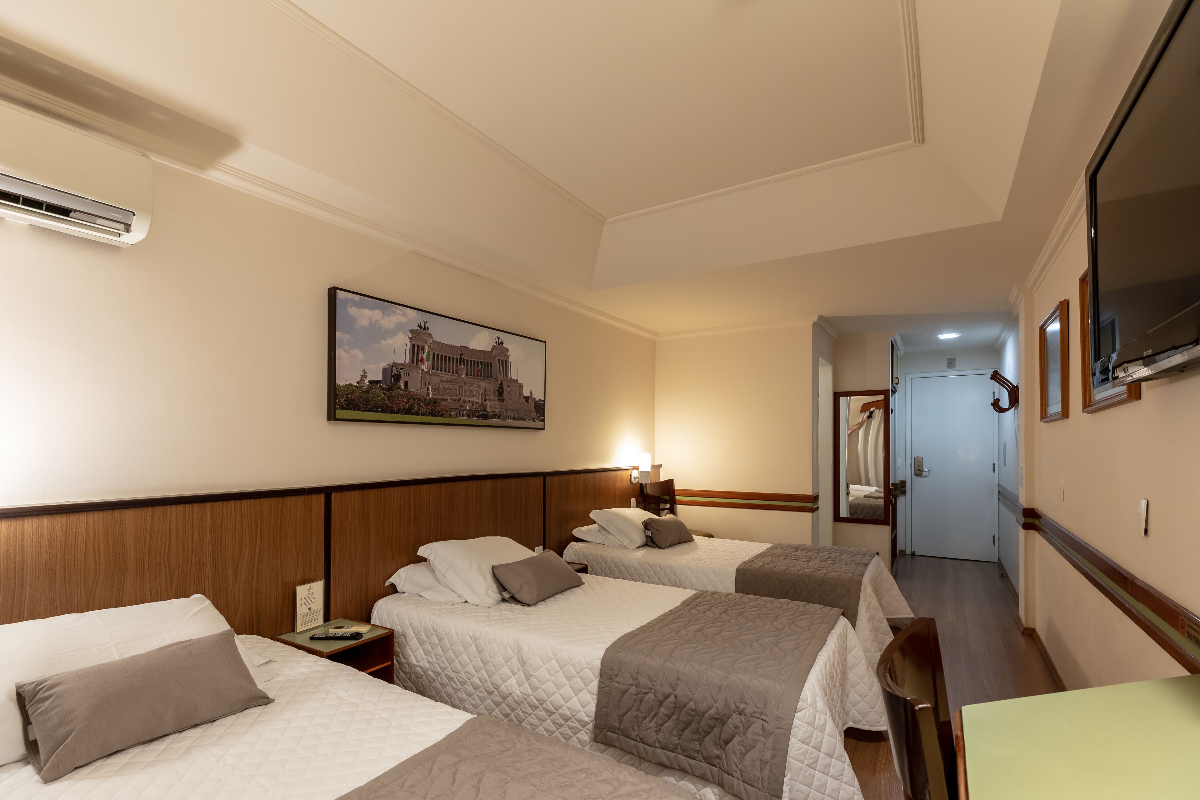 deluxe triple room | minibar, in-room safe, desk, laptop workspace