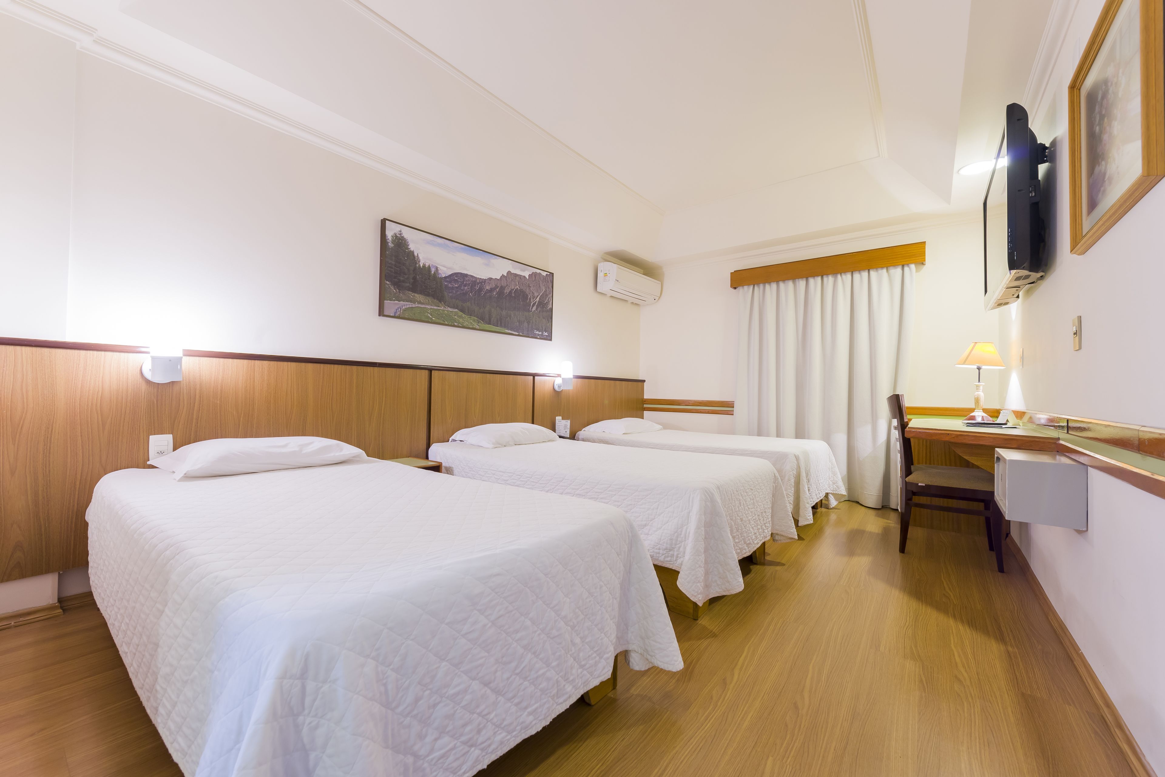 deluxe triple room | minibar, in-room safe, desk, laptop workspace