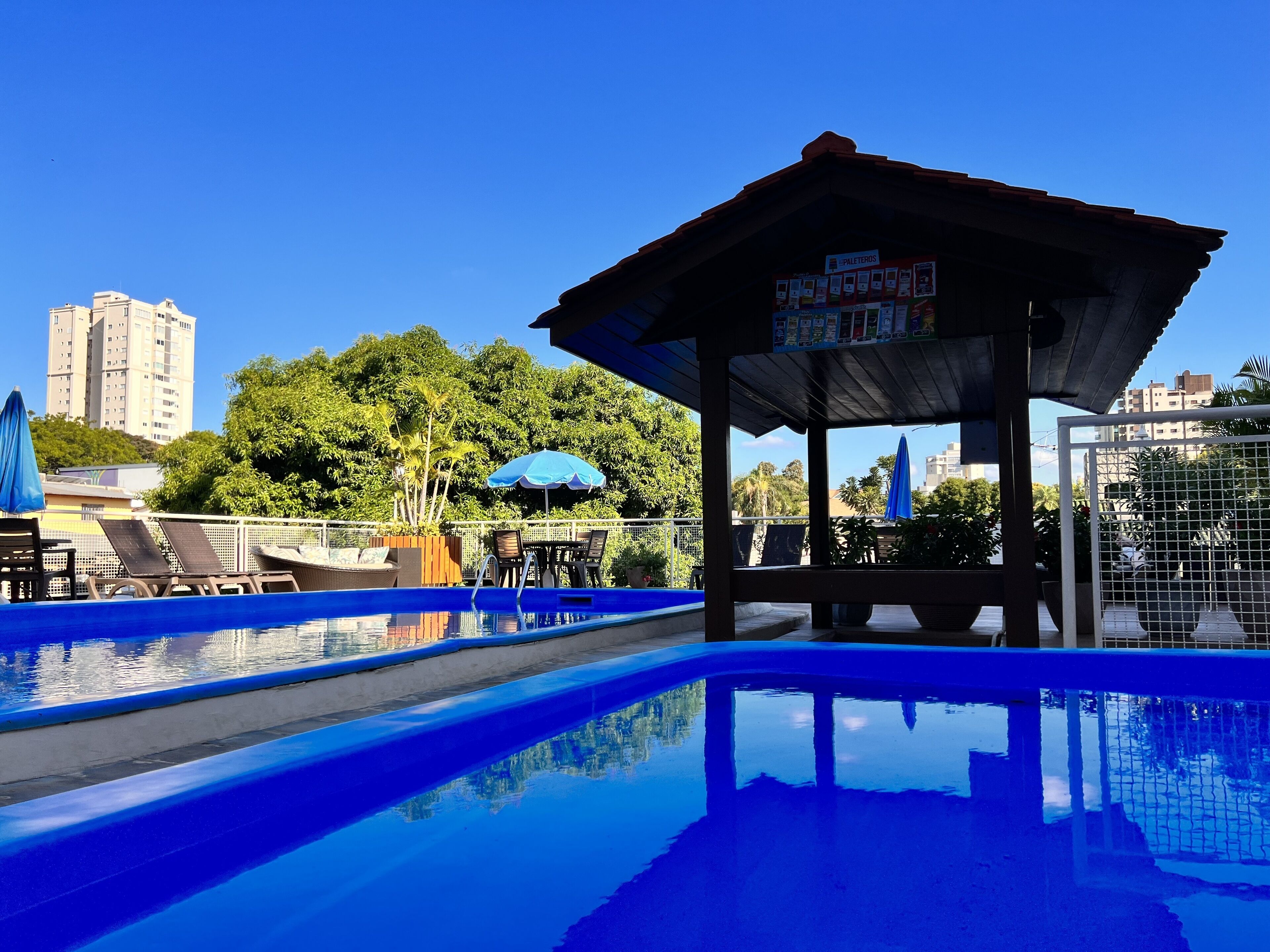 2 outdoor pools, open 8:00 AM to 11:00 PM, pool umbrellas, pool loungers