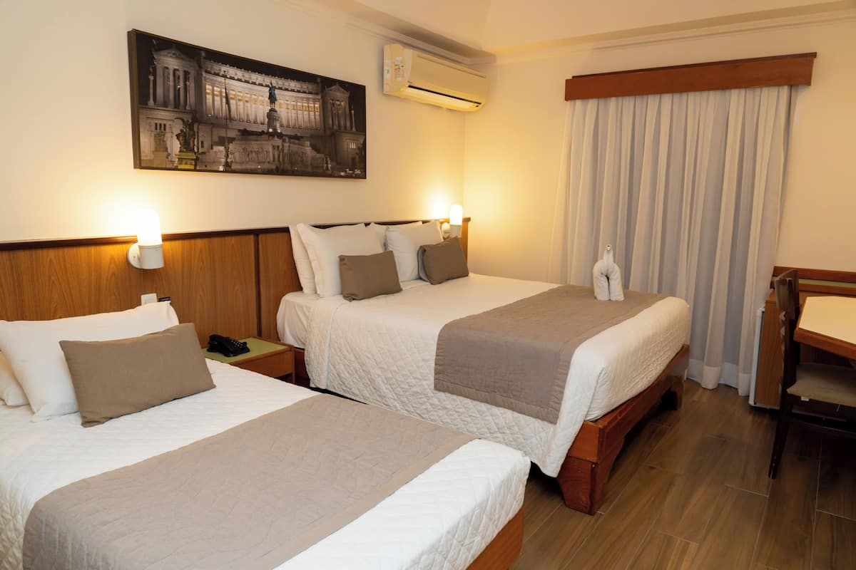 Deluxe Triple Room | Minibar, in-room safe, desk, laptop workspace