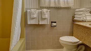 A bathroom with a bathtub, toilet, and sink.