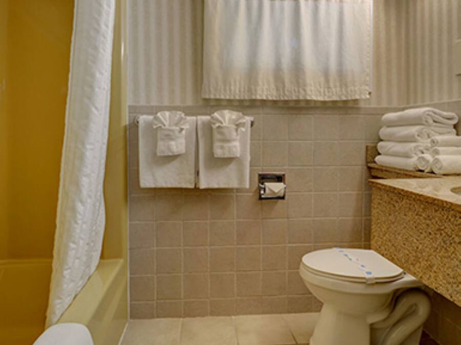 A bathroom with a bathtub, toilet, and sink.