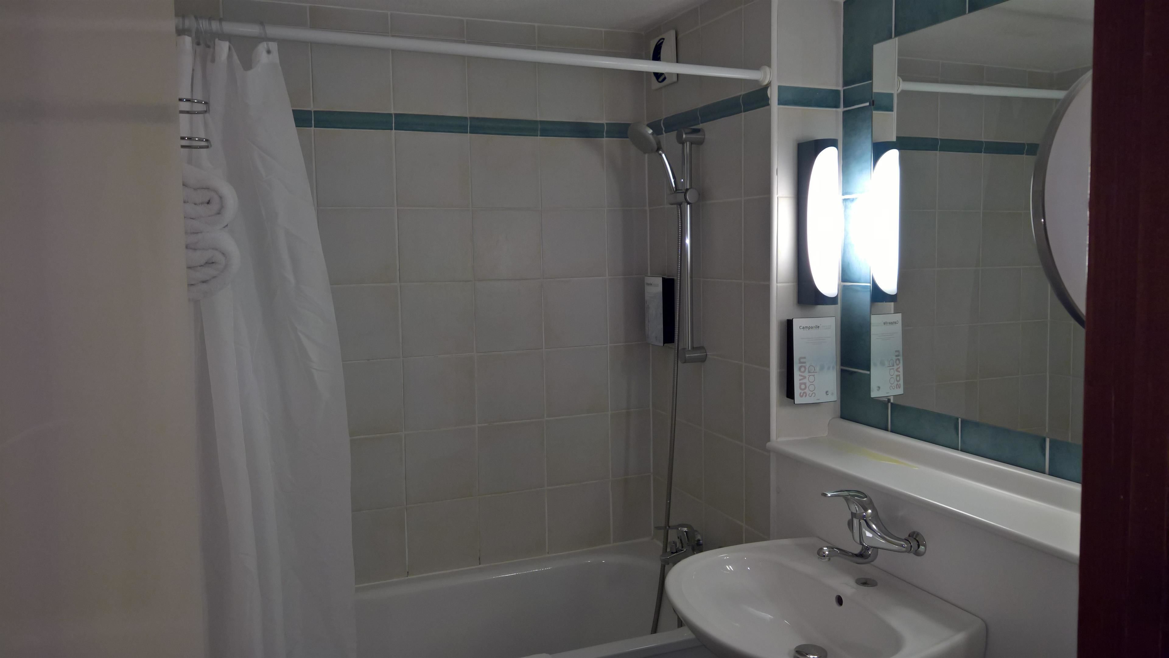 A bathroom with a bathtub, a sink, and a shower.