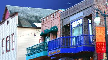 A building with a balcony and a sign that reads "The Expanding Heart."