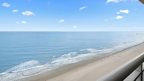A beach view with a clear sky and calm sea.