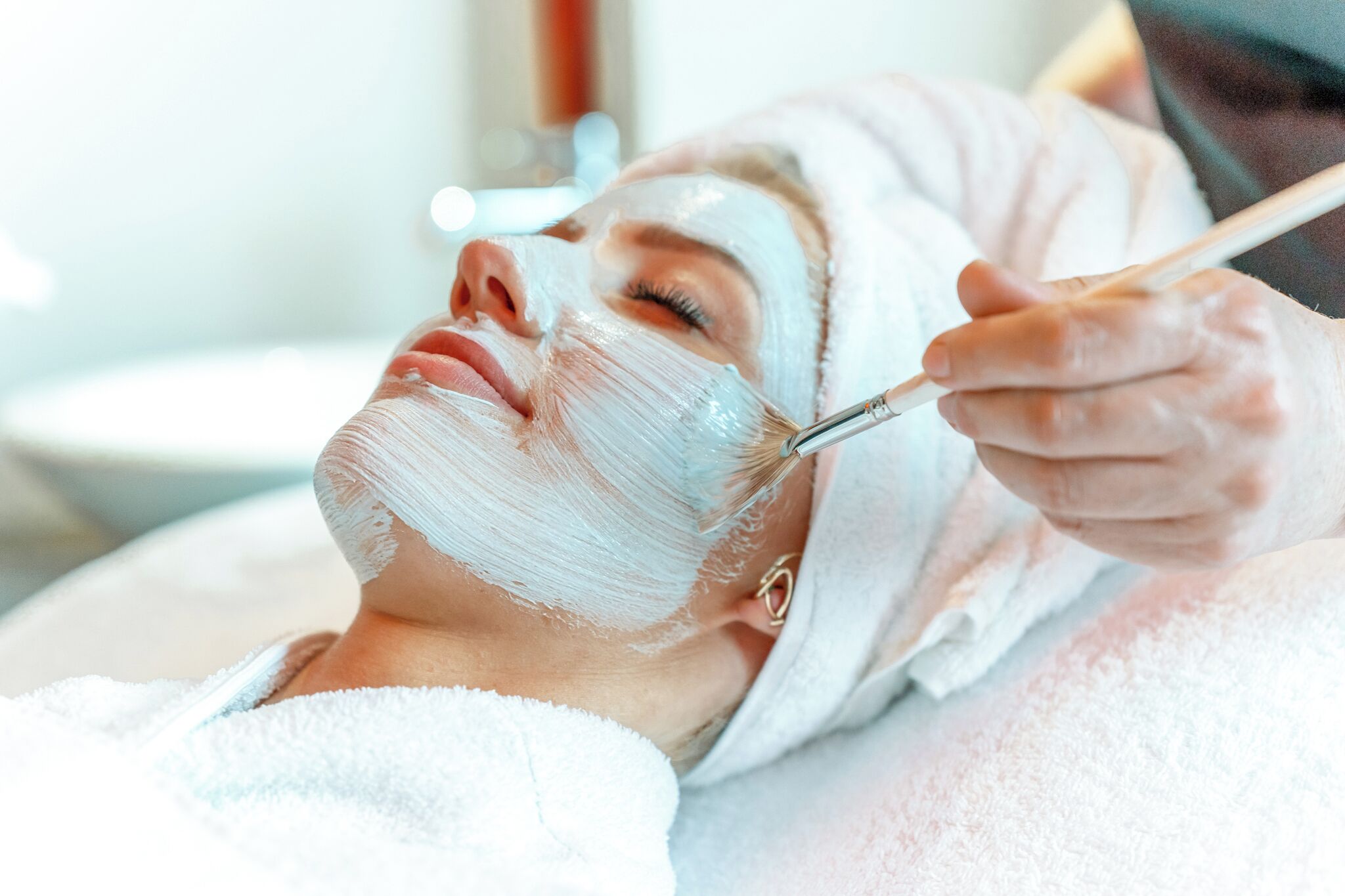 Una persona recibiendo un tratamiento facial con un cepillo.