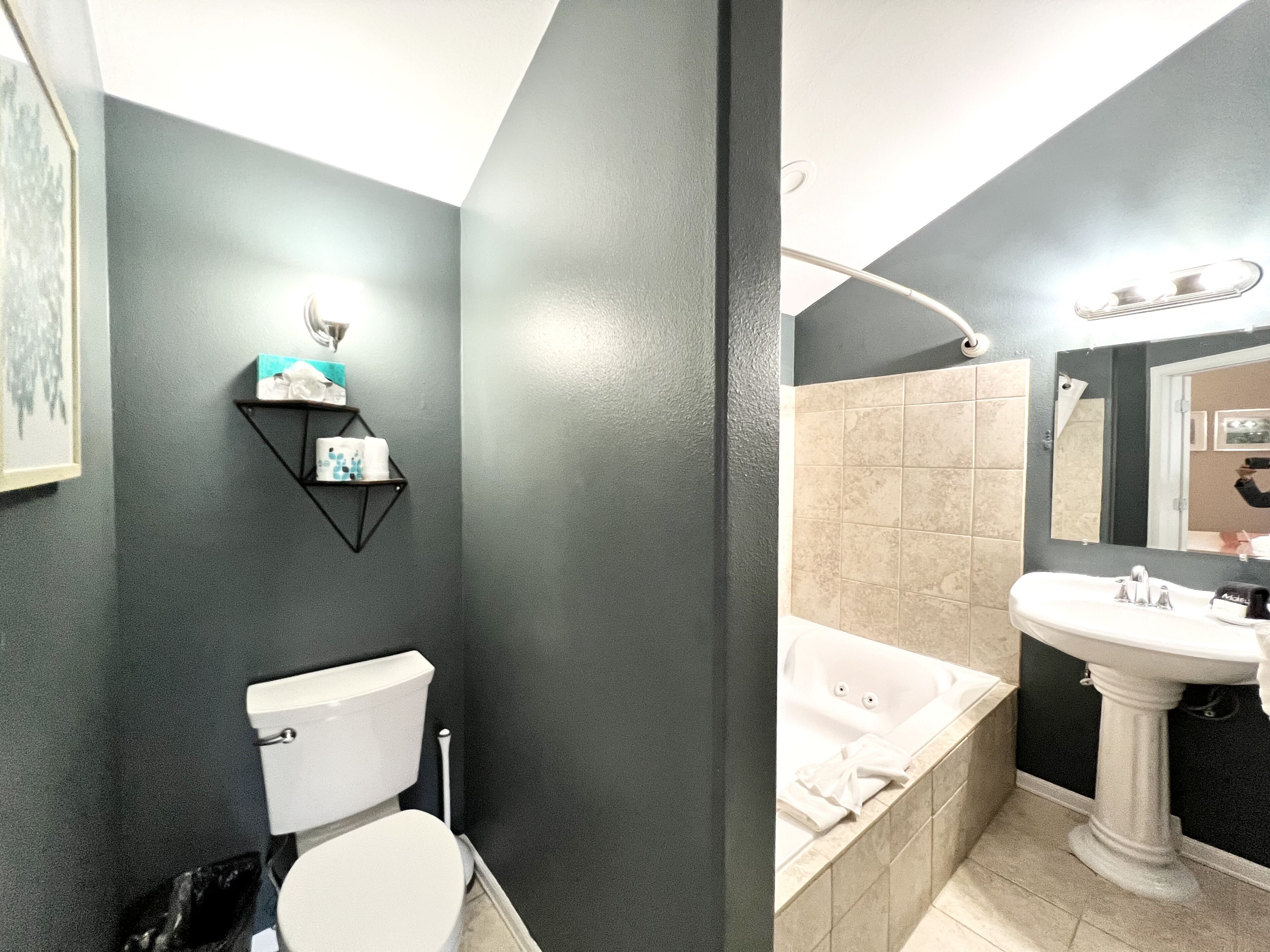 A bathroom with a toilet, sink, and bathtub.