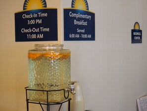 A beverage dispenser with a sign indicating check-in time at 3:00 PM and complimentary breakfast served from 6:00 AM to 10:00 AM. - Days Inn by Wyndham Petoskey (Petoskey)