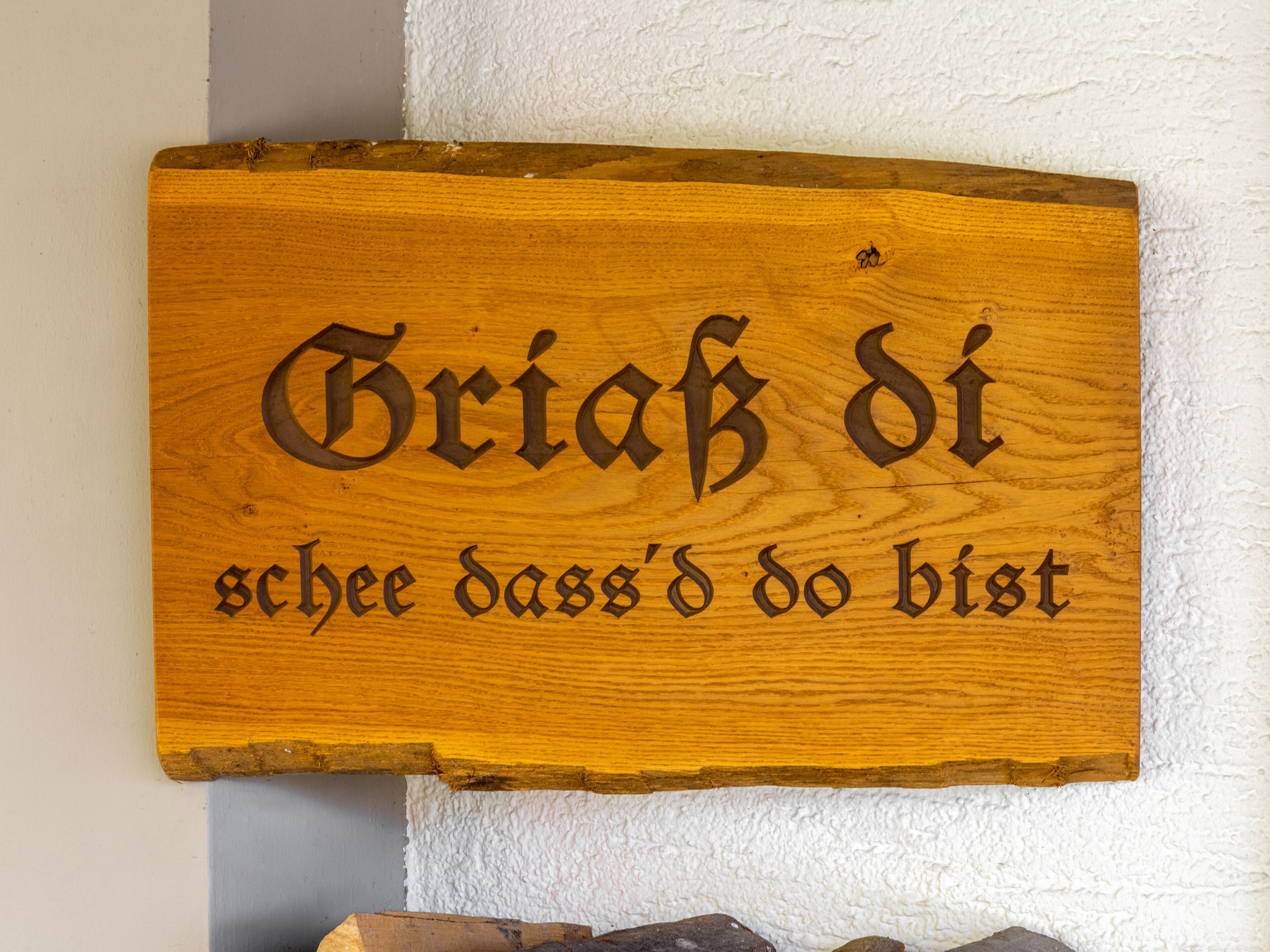 A wooden sign with carved text.