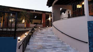 Una piscina al aire libre, sombrillas, sillones reclinables de piscina