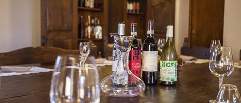 A wooden table with wine bottles and glasses.