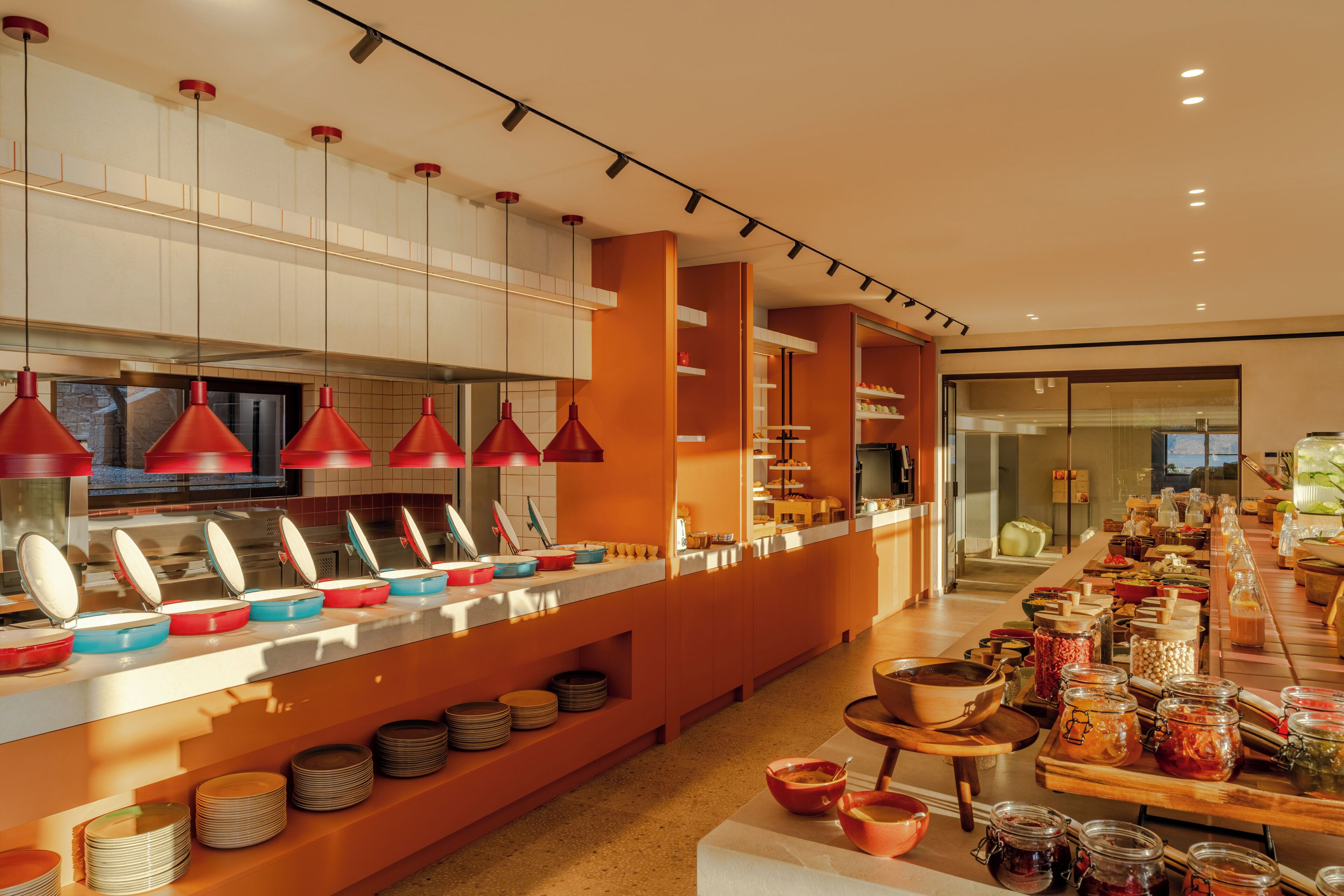 A buffet setup with multiple serving stations, a variety of dishes, and a modern interior design.