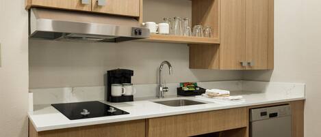 A modern kitchen with wooden cabinets, stainless steel appliances, and a dishwasher.