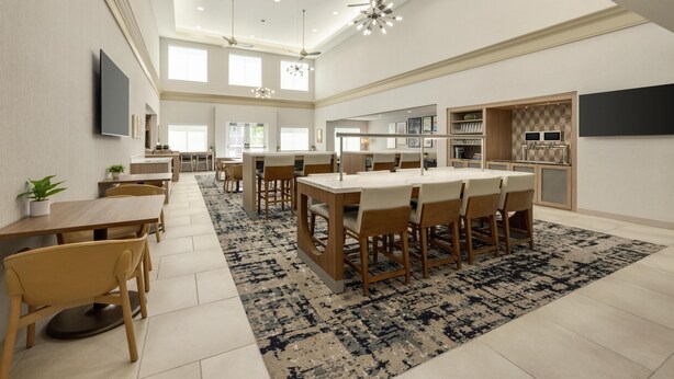 A spacious kitchen with modern appliances, a dining area with a large table and chairs, and a ceiling fan. - Homewood Suites by Hilton Denver West Lakewood (Lakewood)